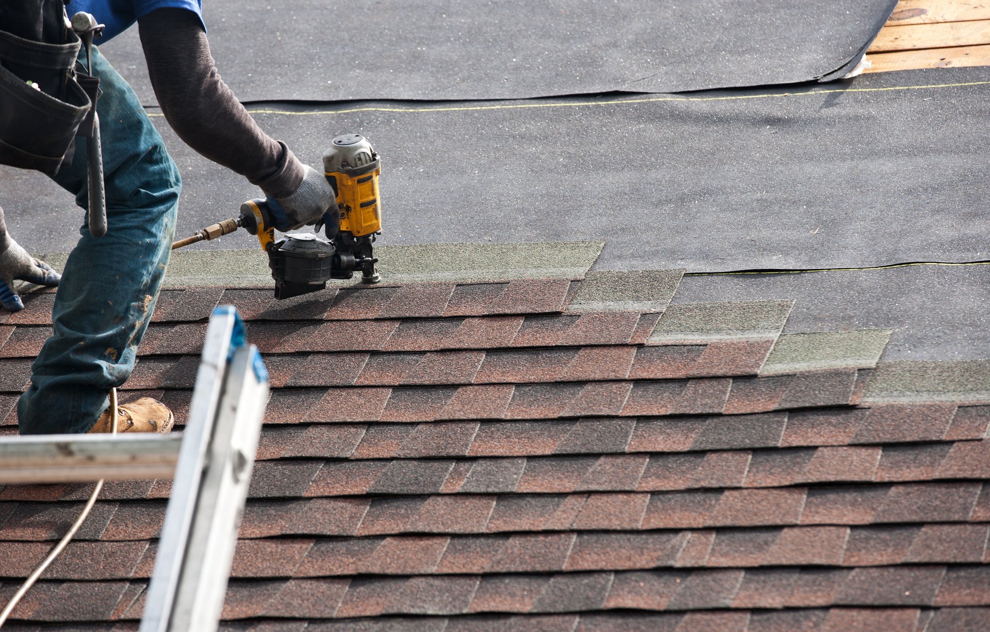 roofers installing new roof on house